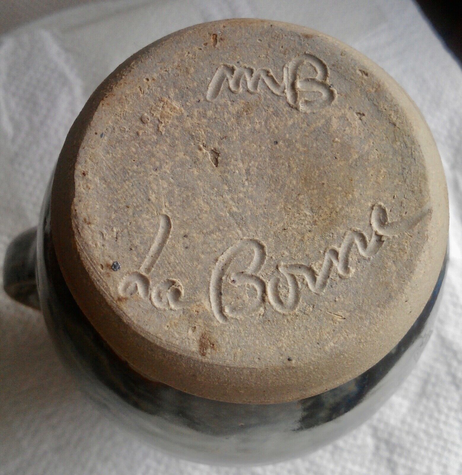 Enamelled ceramic pitcher, signature mb the terminal