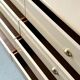 Commode type sideboard with 8 drawers, ivory lacquer and brass details, 1970s design.