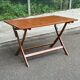 Foldable garden table in solid wood, signed 125x80cm.