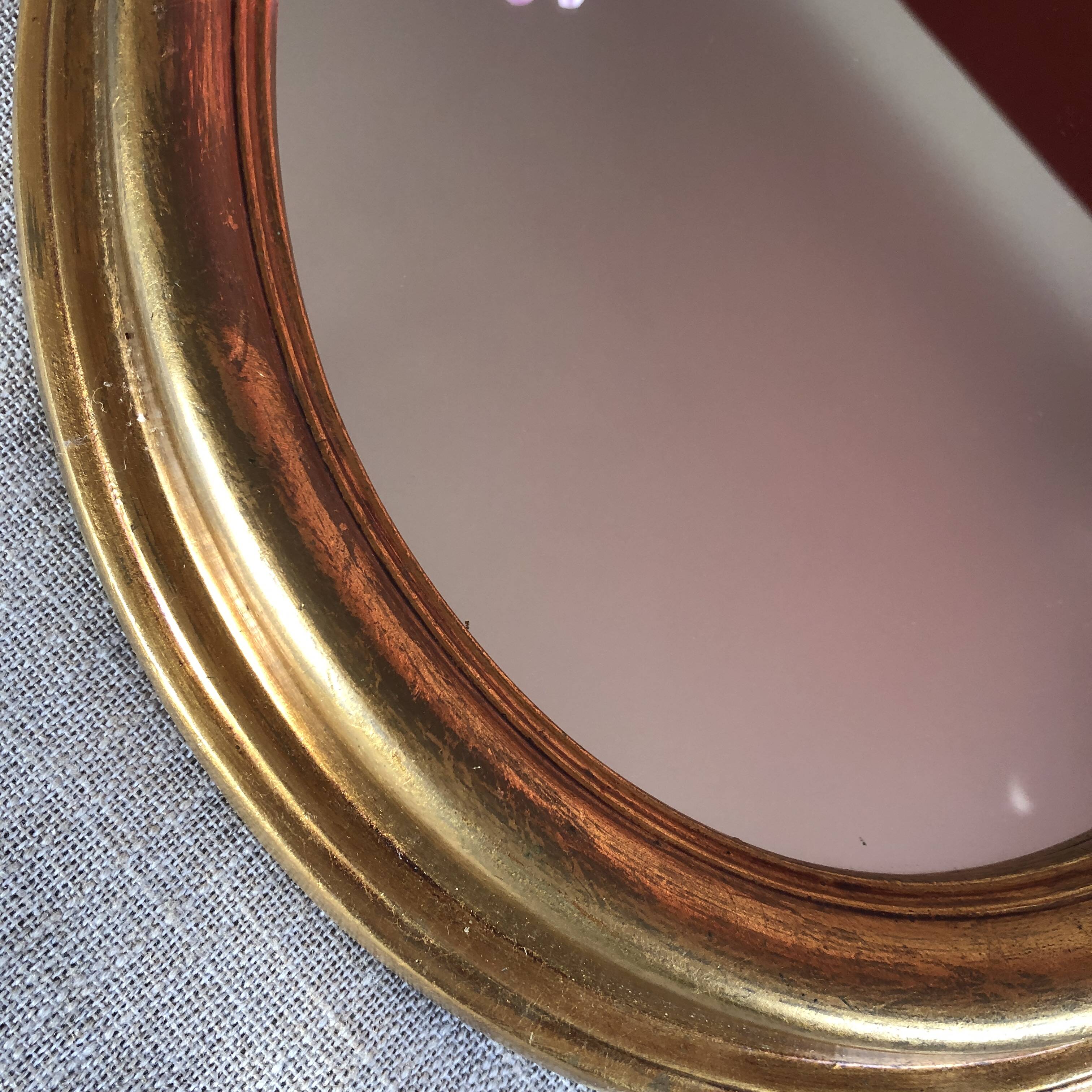 Golden oval mirror