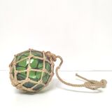 Green ball marine float in glass and rope