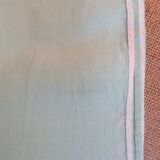 Old embroidered tablecloth in light green color