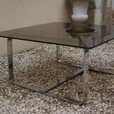 Table basse Roche Bobois 1970 verre fumé piètement en métal chromé.