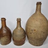 Set of three old enamelled terracotta bottles, 33 cm