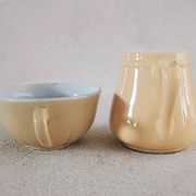 Earthenware cup and milk jar