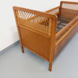 Vintage oak and rattan baby cot from the 1960s.
