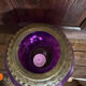 Antique iridescent purple glass lantern with a brass frame.