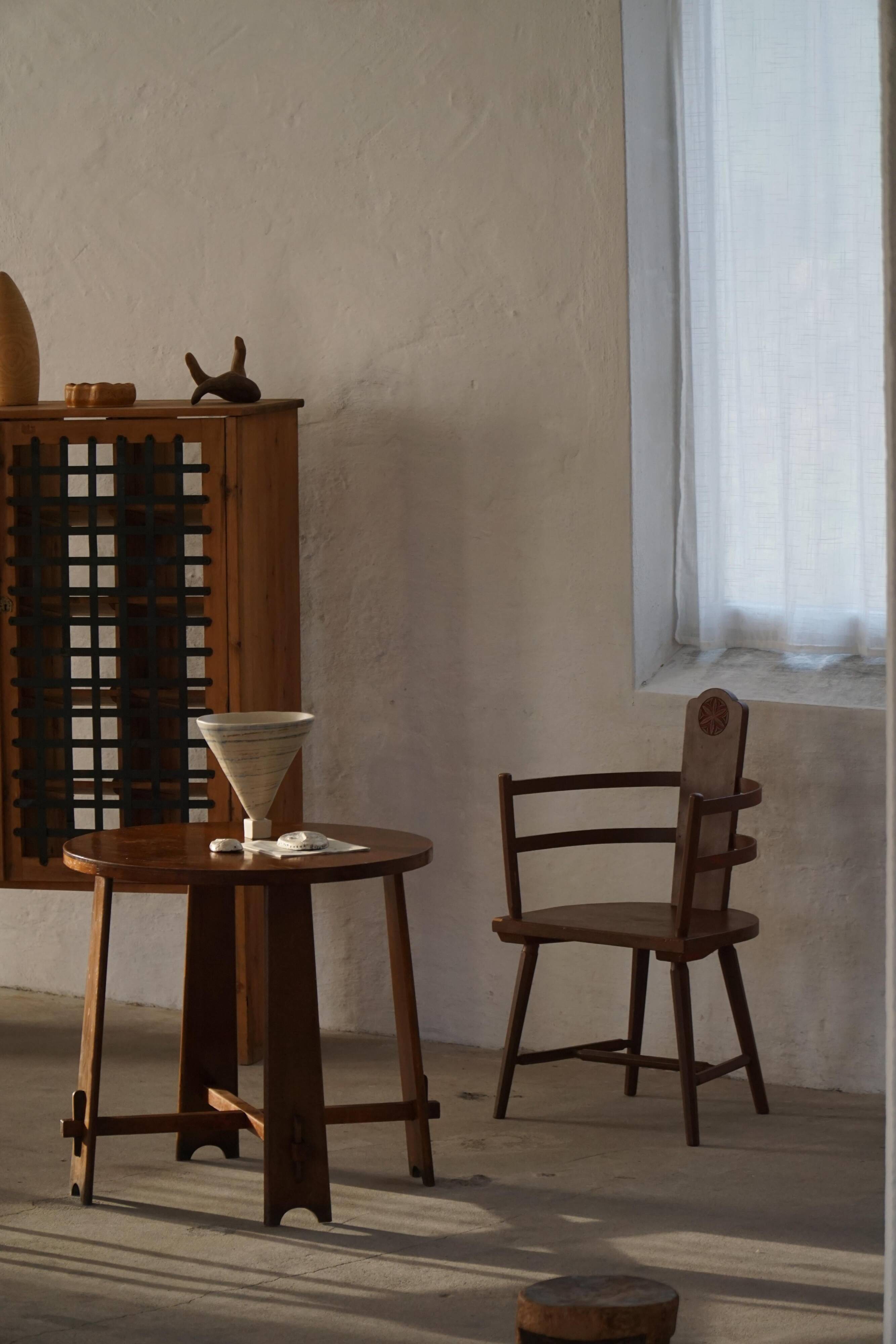 Pair of Scandinavian wooden armchairs with hand-carved folk motifs, 1920s.