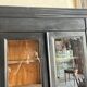 Black painted wardrobe with two glass doors and an interior sideboard.