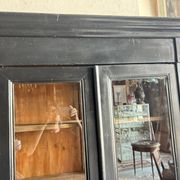 Black painted wardrobe with two glass doors and an interior sideboard.