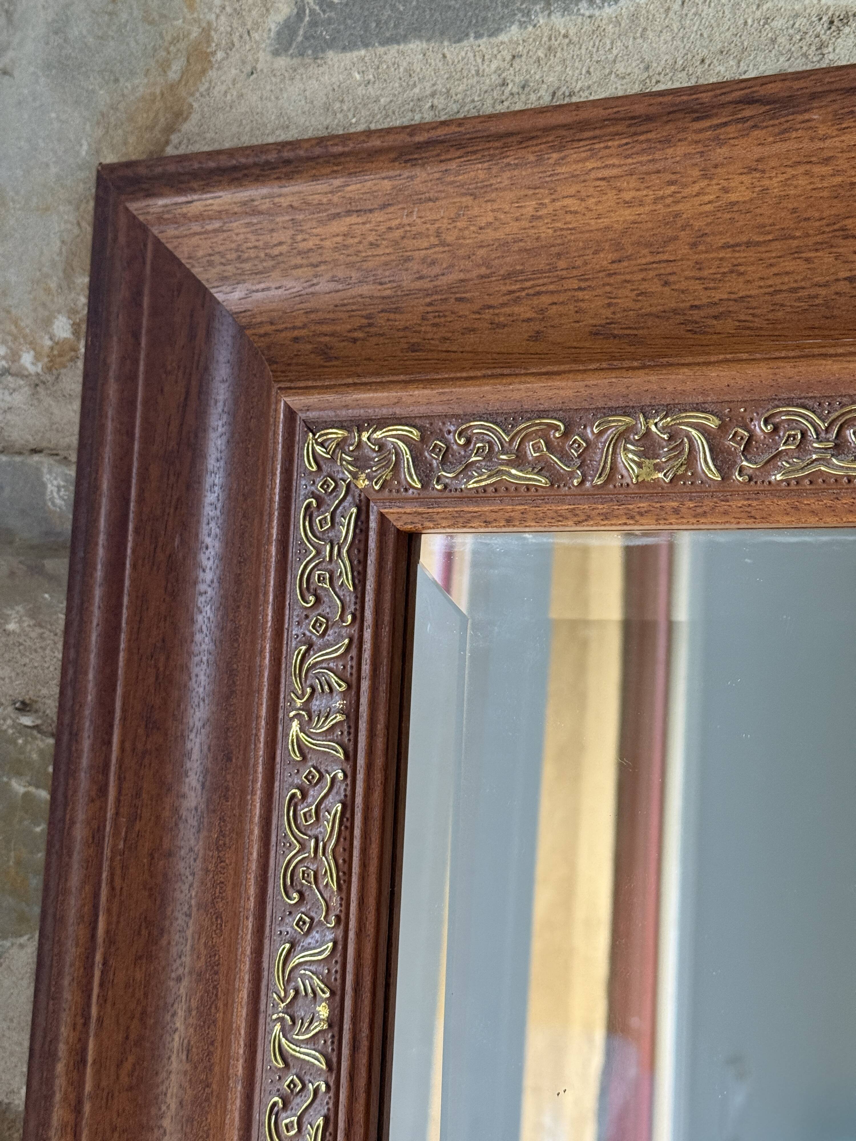Large bevelled tabletop mirror in carved gilded wood.