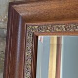 Large bevelled tabletop mirror in carved gilded wood.