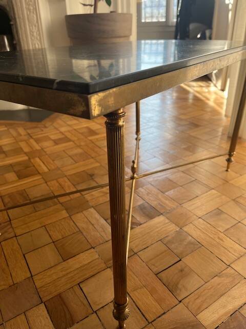 Black marble coffee table with brass legs.