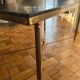 Black marble coffee table with brass legs.