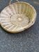 Round presentation basket made of woven wicker and rattan.
