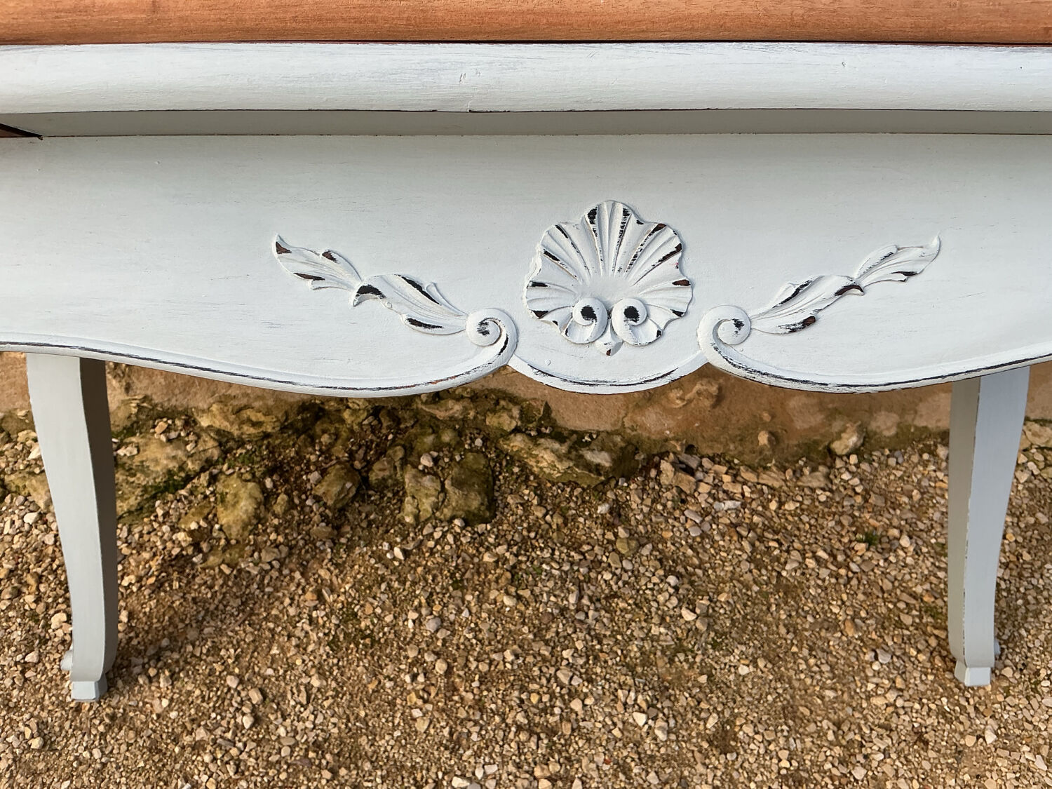 Louis XV style walnut table with a natural wood top.