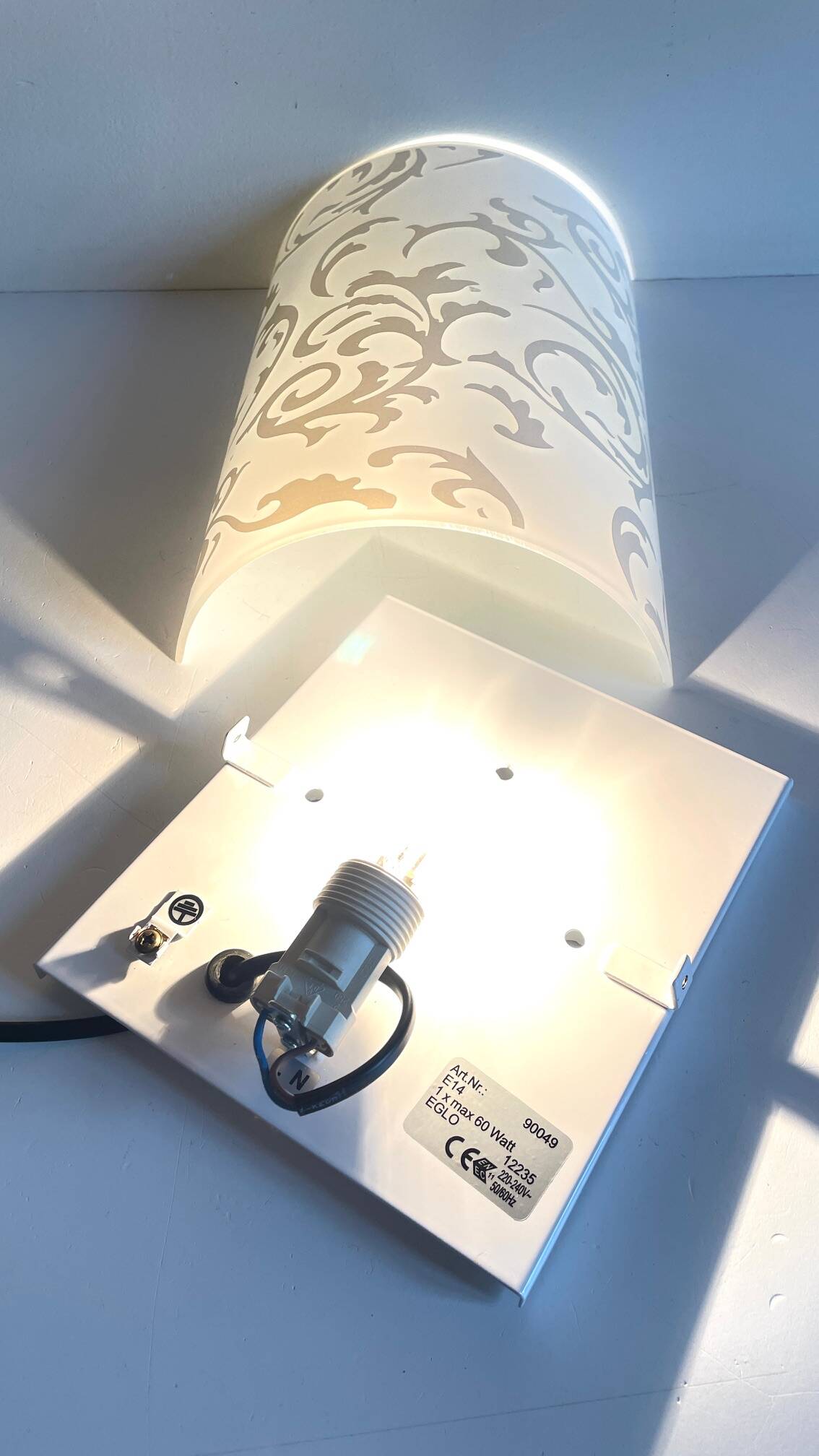 Polished and screen-printed glass sconce by eglo