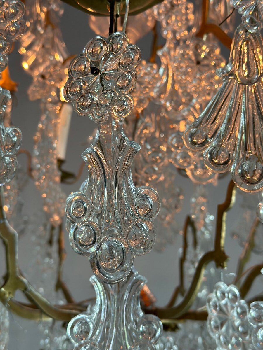 Bronze cage chandelier adorned with molded glass pendants in the shape of peacock feathers, circa 1800