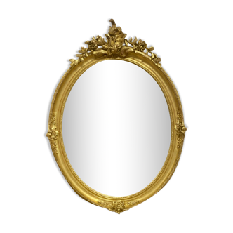 Oval mirror in gilded wood 70x49cm