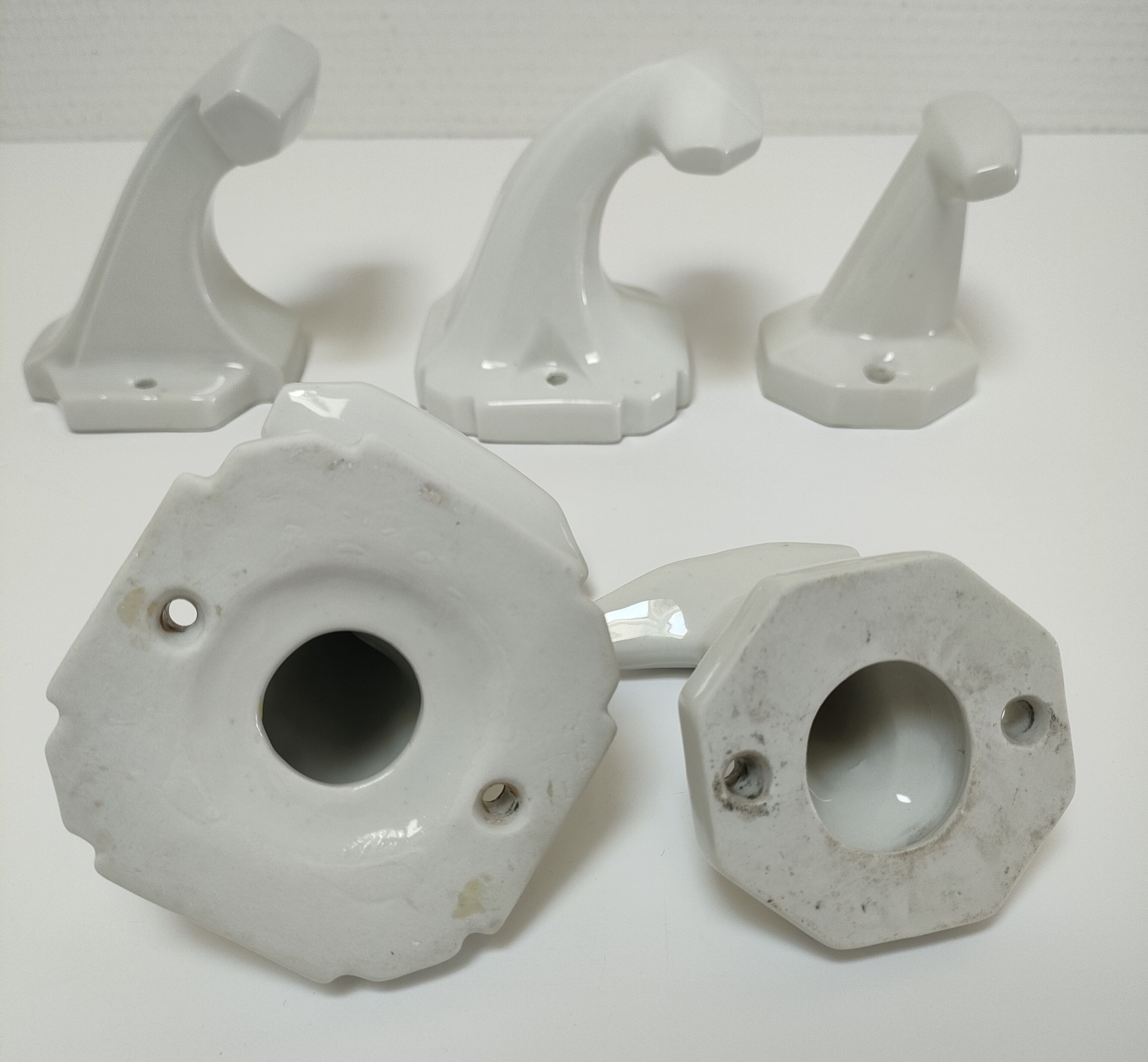 Five art deco white porcelain hooks