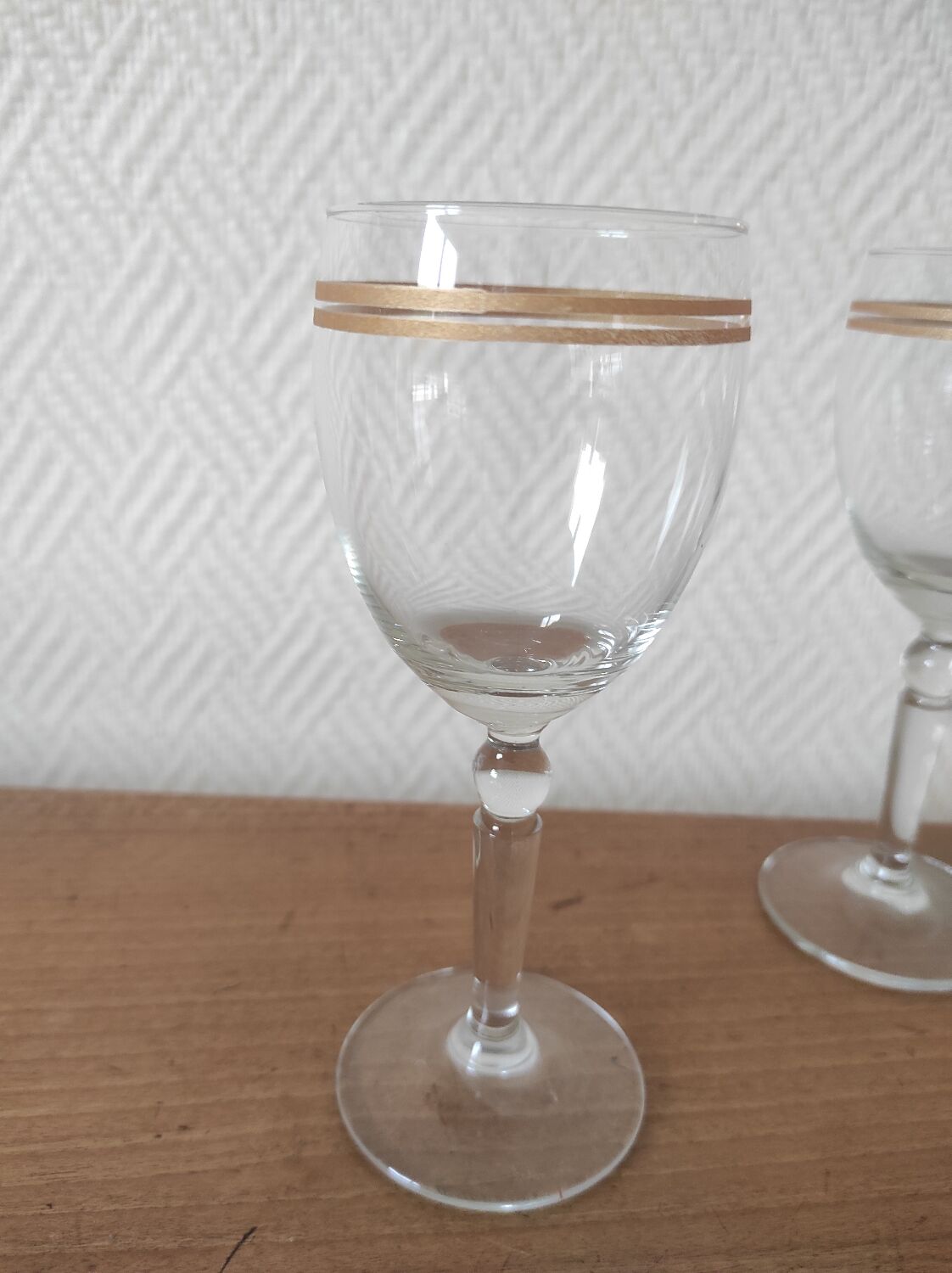 Set of 6 glasses with gold band decorations.