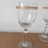 Set of 6 glasses with gold band decorations.