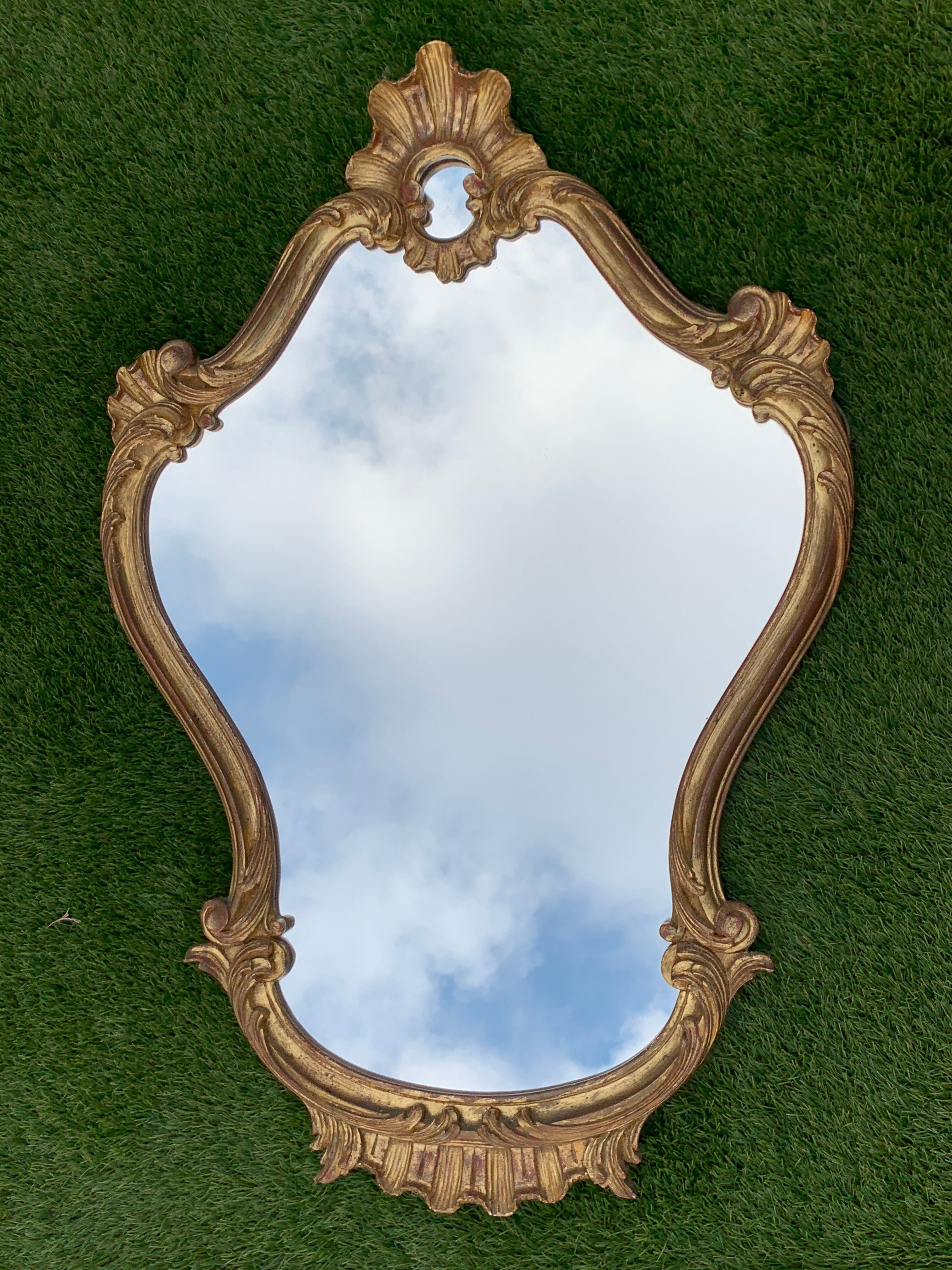 Old mirror in carved wood and gilded leaf, Louis XV rocaille style, twentieth century 59x87cm