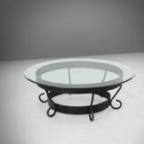 Rustic round coffee table with wrought iron base and glass top, France, 1930s