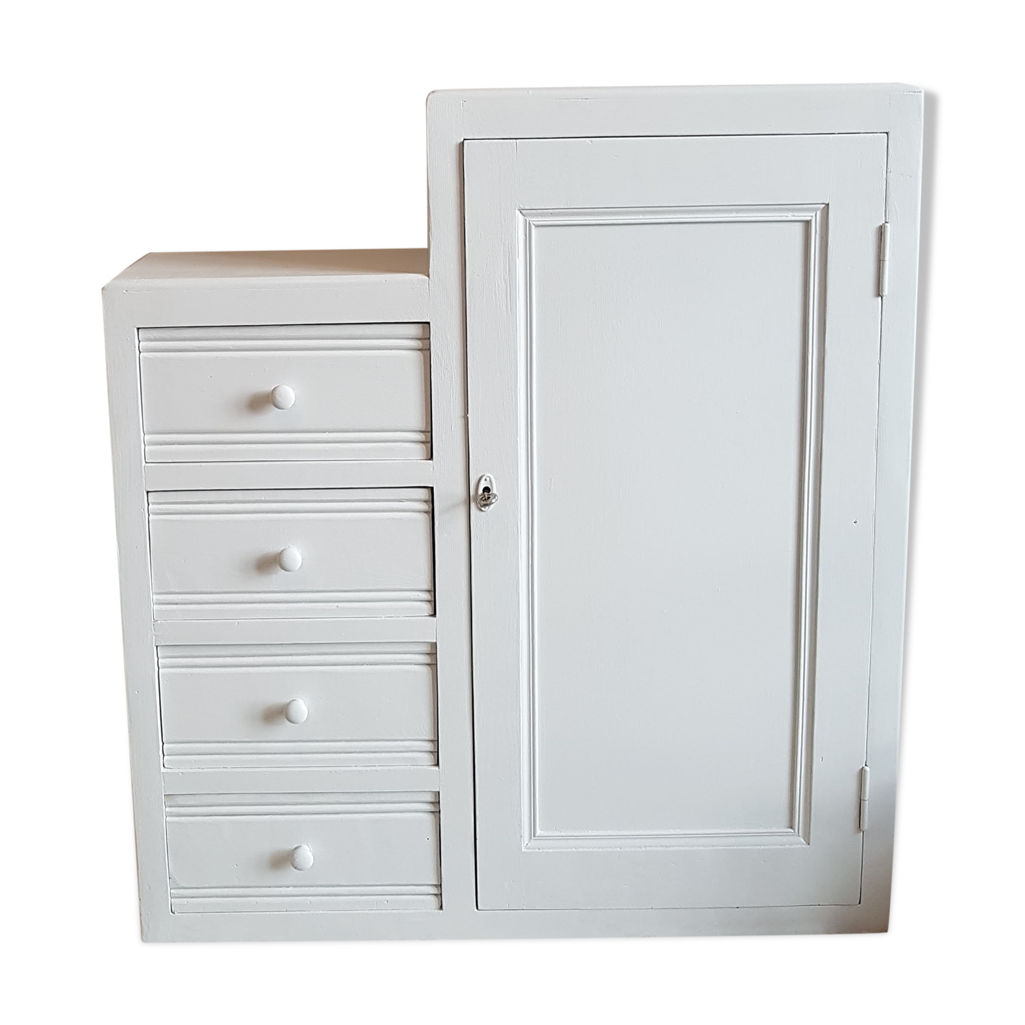 Old white asymmetrical chest of drawers