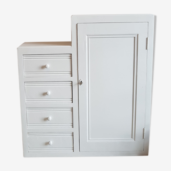 Old white asymmetrical chest of drawers