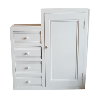 Old white asymmetrical chest of drawers