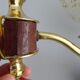 Golden wall lamps with round glass shades and teak veneer