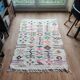 Moroccan white rug with Berber patterns.