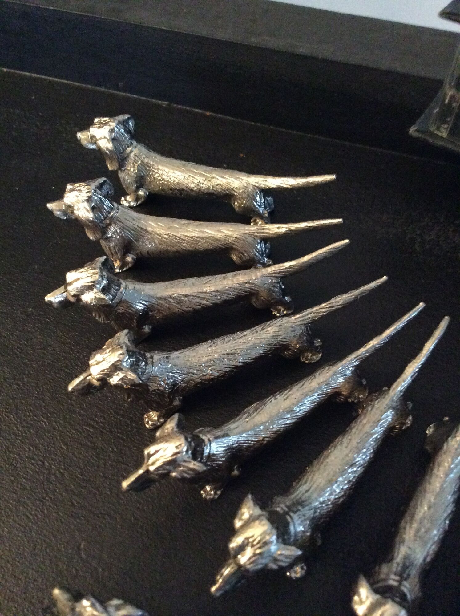 Series of 12 vintage dachshund knife holders in silver metal