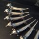 Series of 12 vintage dachshund knife holders in silver metal