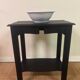 Small Art Deco console reinterpreted – matte black wood with drawer
