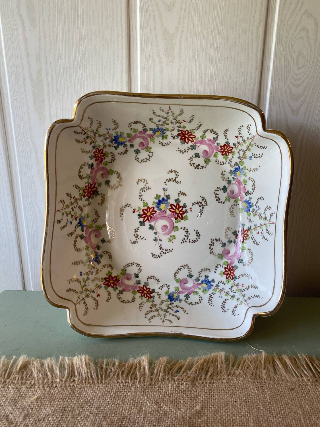 Old hollow porcelain dish with floral decoration and gold trim
