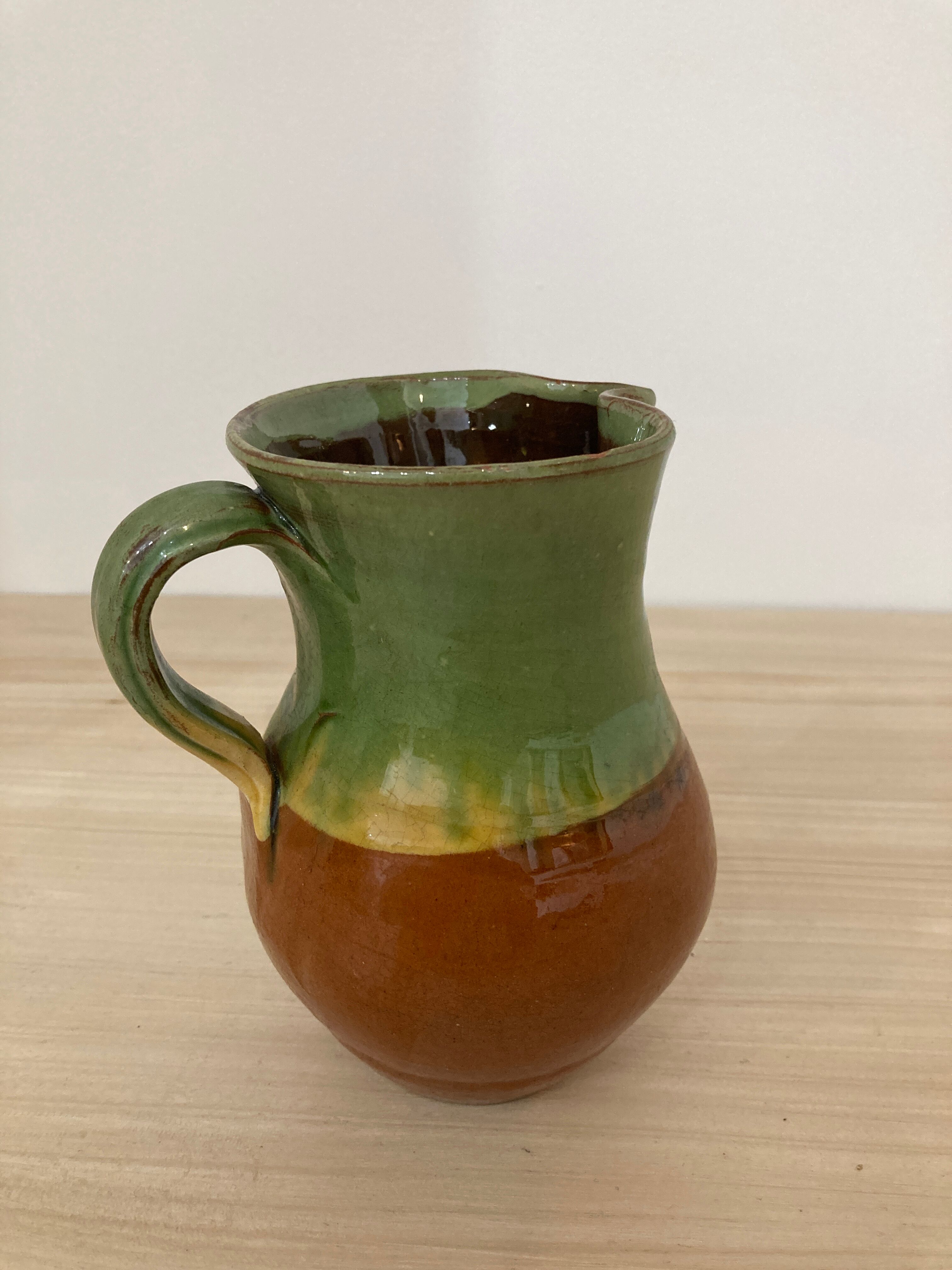 Green and brown ceramic pitcher