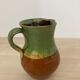Green and brown ceramic pitcher