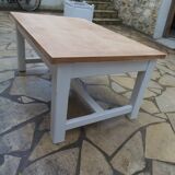 Coffee table with pearl grey legs and a wooden top.