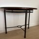 Half-moon console grange in solid cherry wood and wrought iron with a glass top.