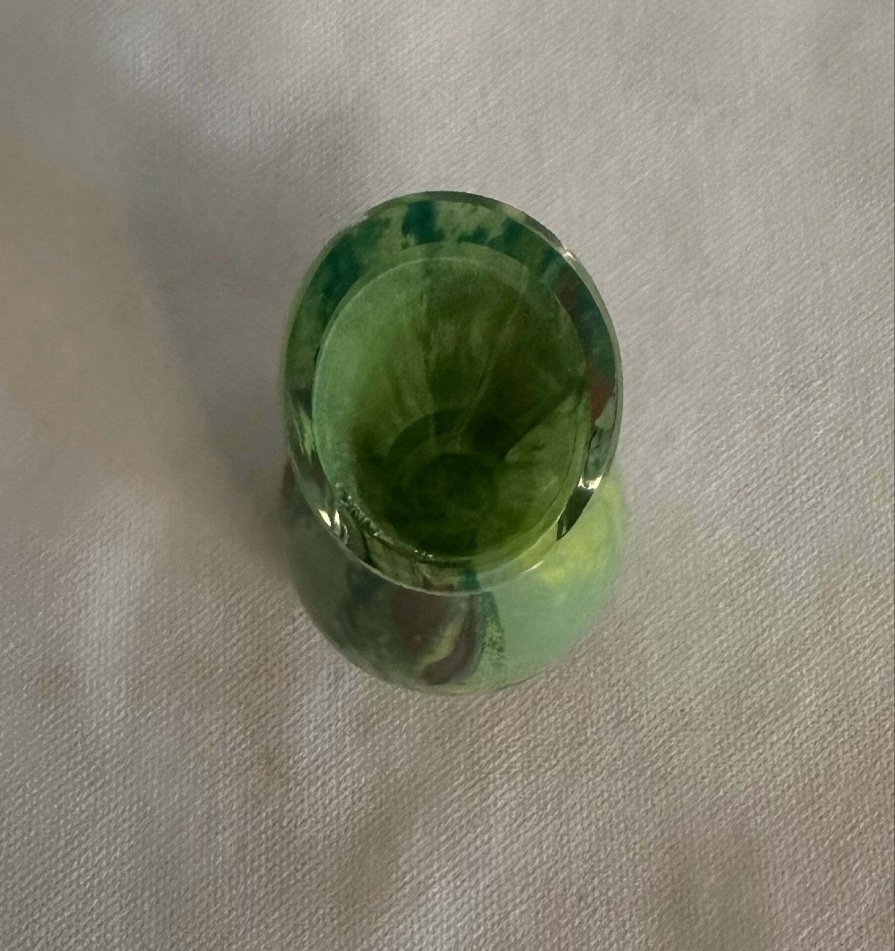 Single flower vase in blown green glass