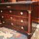 Commodity with mahogany detached columns and Empire gilded bronze ornaments