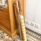 Vintage folding deckchair with yellow striped canvas