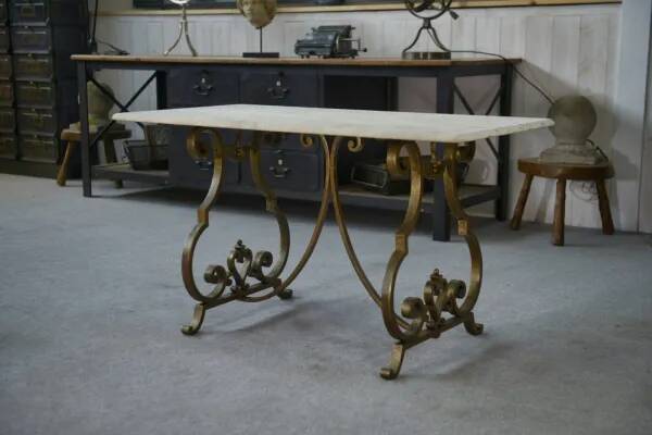 Side table with a gilt wrought iron base attributed to Gilbert Poillerat, with a travertine top, 1940s