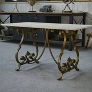 Side table with a gilt wrought iron base attributed to Gilbert Poillerat, with a travertine top, 1940s