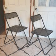 Pair of folding chairs in perforated metal