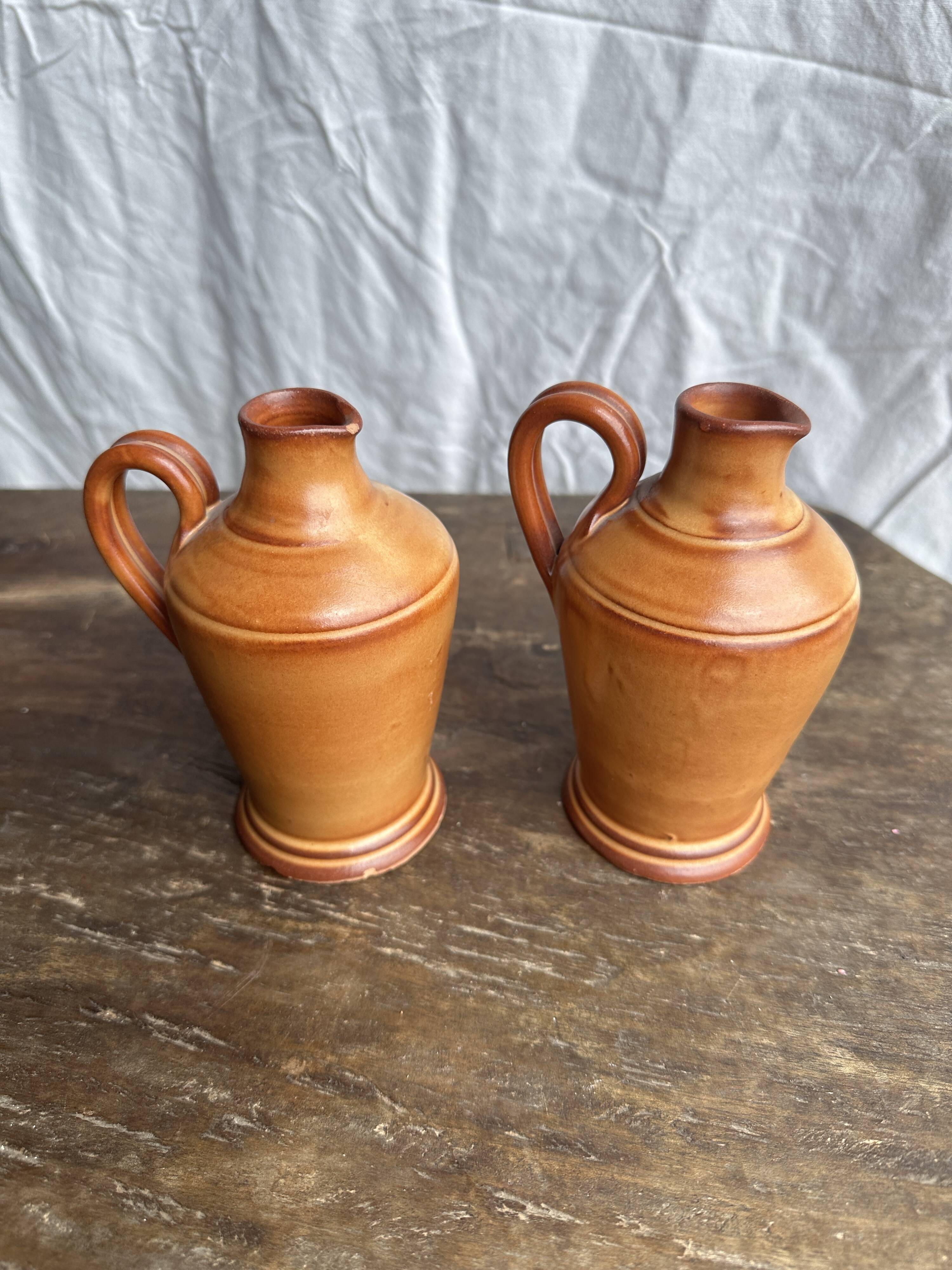 Pair of mini orange stoneware pitchers