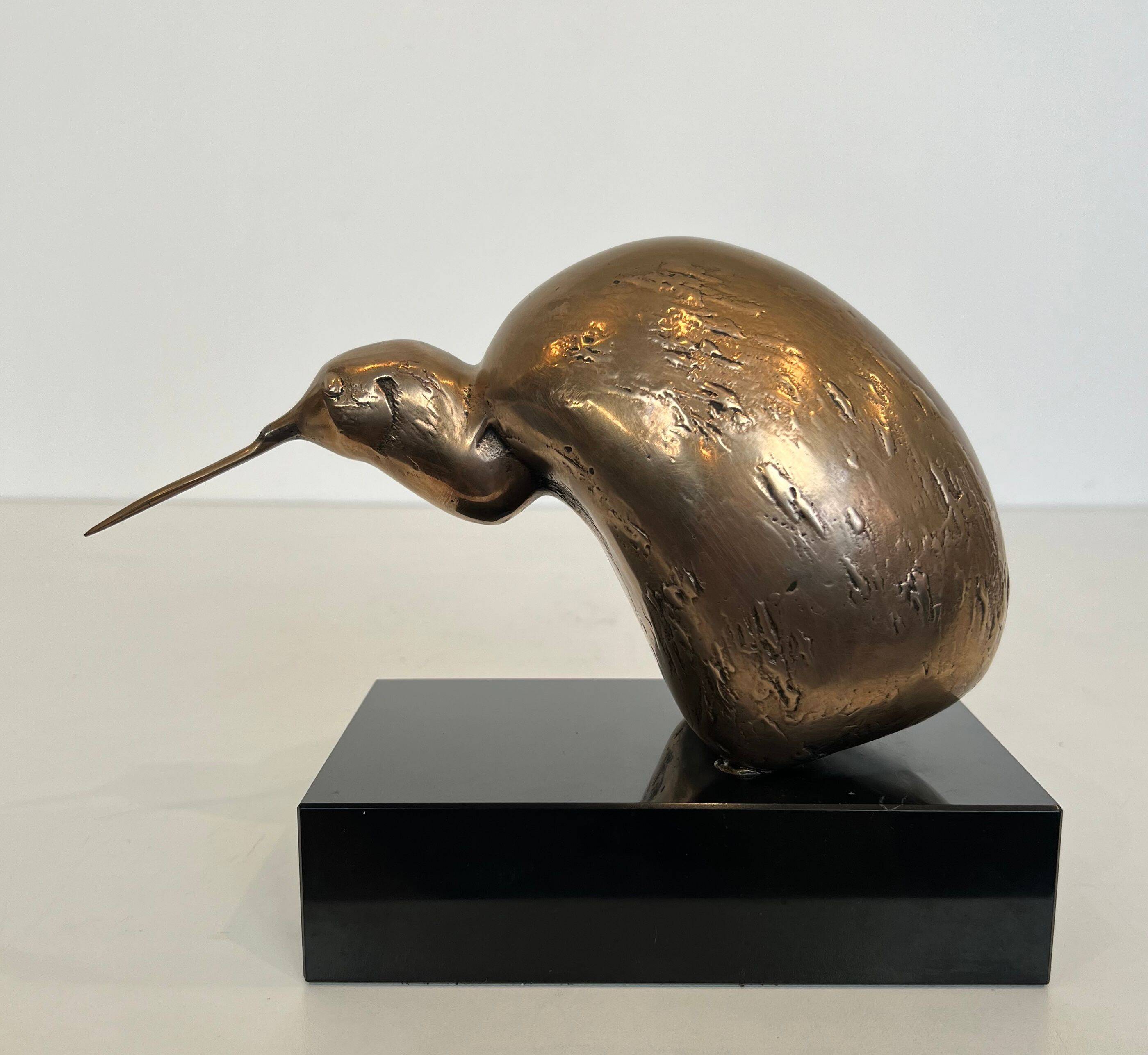 Bronze sculpture representing a stylised bird on a black marble base, signed and numbered.