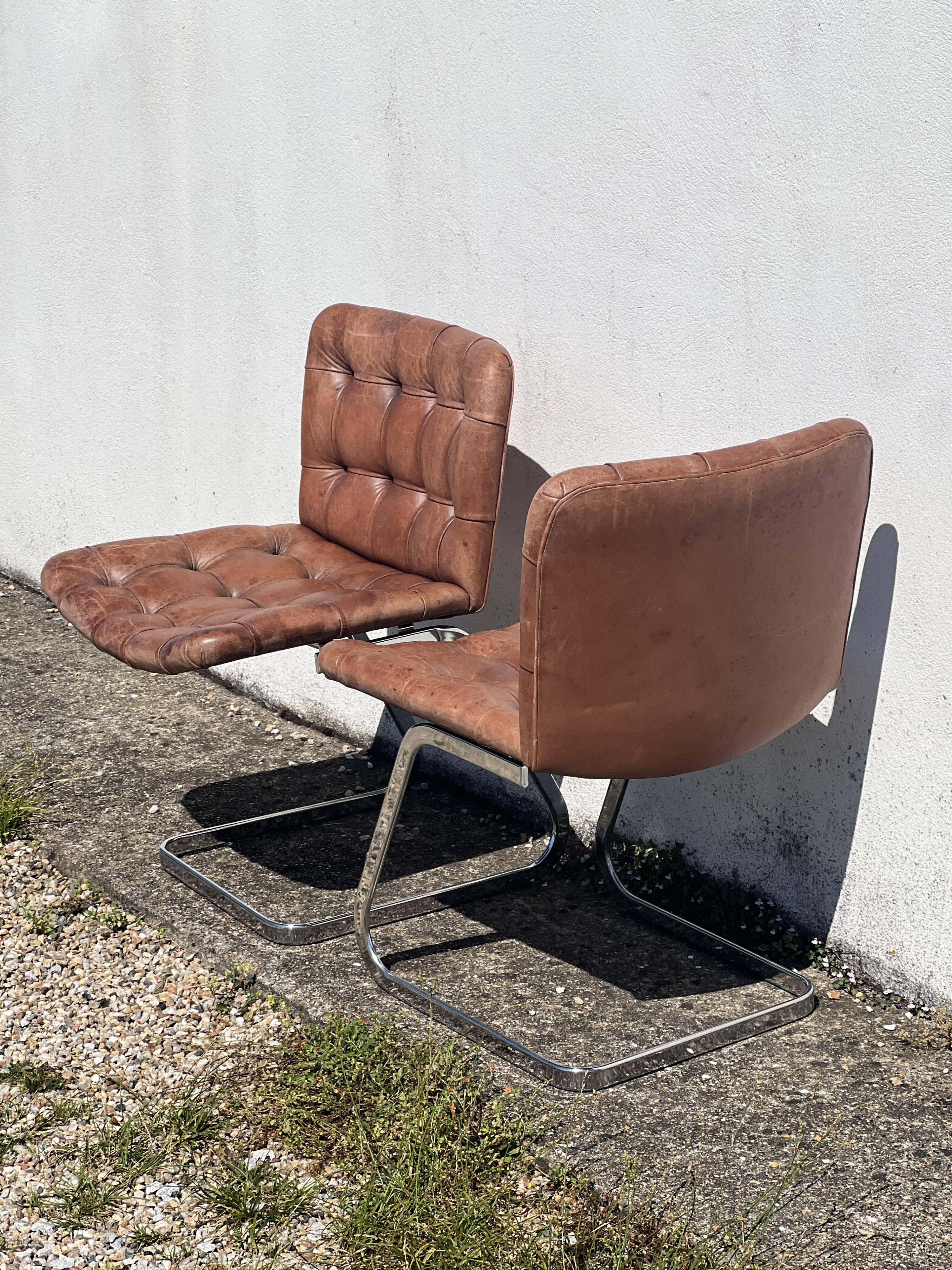 Pair of leather chairs by Robert Haussman